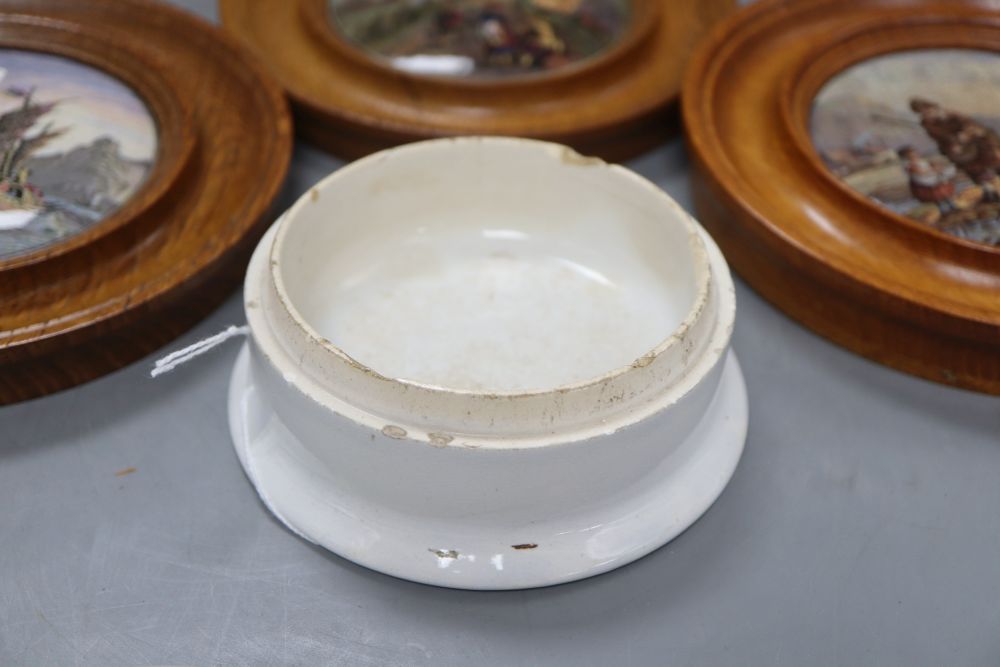 Three Prattware pot lids in oak frames and another Prattware pot